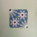 Fizaan Artisan Moroccan-style 20×20cm porcelain tile featuring a blue, green and soft pink geometric floral pattern.