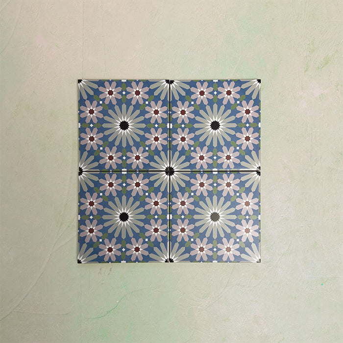 Fizaan Artisan Mini Moroccan-style 15×15cm porcelain tiles laid in a repeating geometric pattern, featuring blue, green and soft pink star motifs.