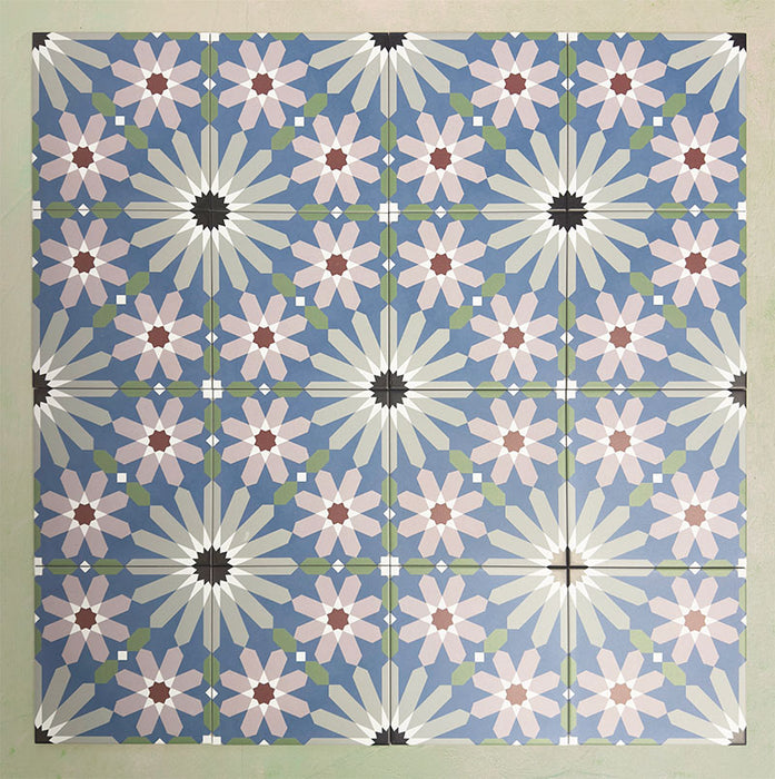 Fizaan Artisan Moroccan-style 20×20cm porcelain tiles laid in a repeating geometric pattern, featuring blue, green and soft pink star motifs.