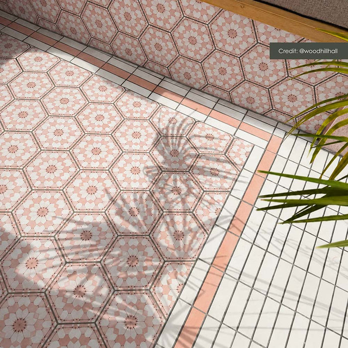 Outdoor tiled area featuring Atlas Pink Mini Brick Matt 5cm x 15cm tiles used as a soft pink border around Moroccan style hexagon patterned tiles, creating a coordinated decorative floor design.