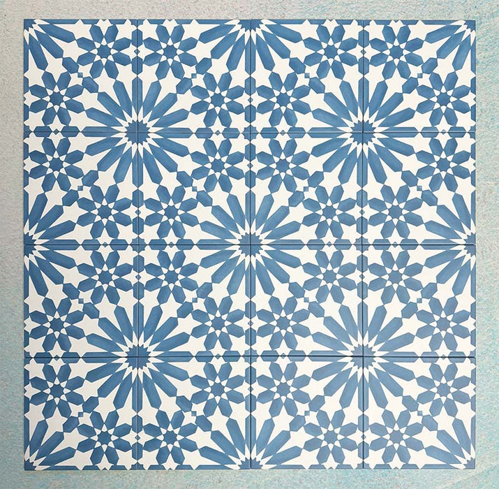 Arrangement of Fizaan Azure Blue 20x20cm Moroccan-style porcelain tiles, showcasing a repeating geometric pattern in vibrant blue and white tones.
