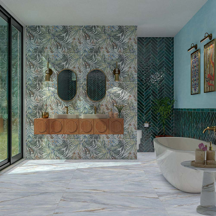 Bathroom featuring Barbados 60cm x 120cm wall and floor tiles with a botanical leaf design, paired with blue herringbone tiles, a freestanding bath, wooden vanity and brass details.
