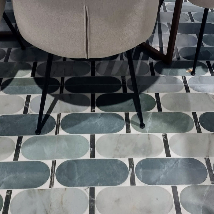 Close-up of Bassano Abacus 3D Décor 60 × 120cm patterned wall and floor tiles, showcasing geometric rounded detailing in soft green and marble-effect tones with a contemporary decorative finish.