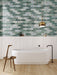 Bathroom interior featuring Bassano Abacus 3D Décor 60 × 120cm patterned wall and floor tiles, styled with a freestanding bath, marble-effect wall panels, warm wood flooring, and contemporary brass lighting.