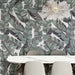 Dining area featuring Bassano Bali 3D Décor 60 × 120cm patterned wall and floor tiles, styled with tropical leaf detailing, marble-effect surfaces, soft neutral seating, and contemporary lighting for a bold interior statement.