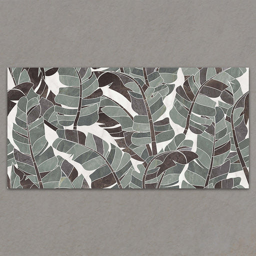Bassano Bali 3D Décor 60 × 120cm patterned wall and floor tile featuring layered tropical leaf detailing in soft green, grey, and marble-effect tones with a bold contemporary decorative finish.