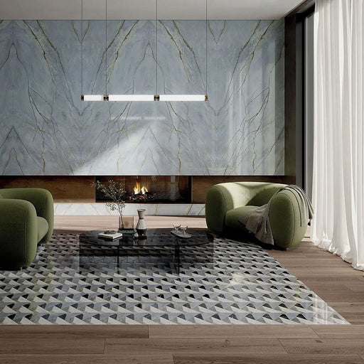 Living room featuring Bassano Diamond Tips 3D Décor 60 × 120cm patterned wall and floor tiles, styled with marble-effect feature walls, sculptural green seating, wood flooring, and contemporary lighting for a luxurious modern interior.