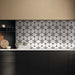 Kitchen interior featuring Bassano Flowers 3D Décor 60 × 120cm patterned wall and floor tiles, styled as a statement splashback with dark cabinetry, warm neutral walls, and contemporary wooden accessories.