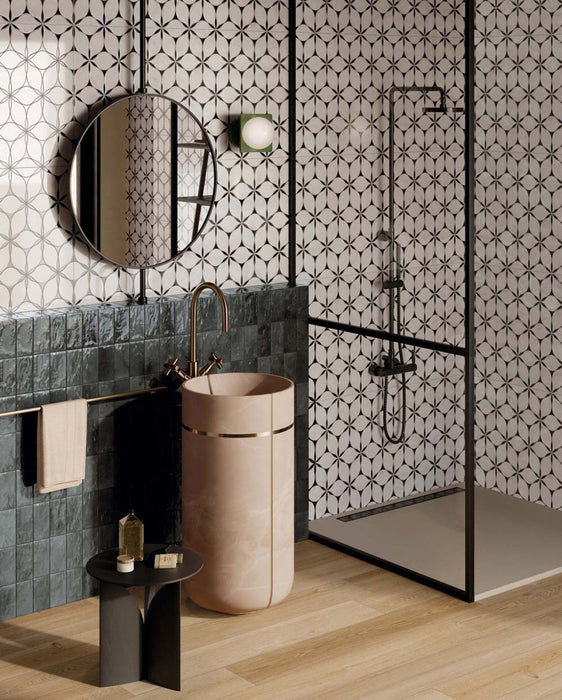 Bathroom interior featuring Bassano Flowers 3D Décor 60 × 120cm patterned wall and floor tiles, paired with a walk-in shower, blush pink basin, dark fittings, and textured green wall tiles for a contemporary statement look.