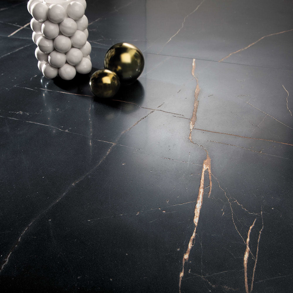 Close-up of Bassano Precious Noir Lux 3D 60 × 120cm marble-effect wall and floor tiles, showcasing deep black tones with striking gold veining and a luxurious polished contemporary finish.