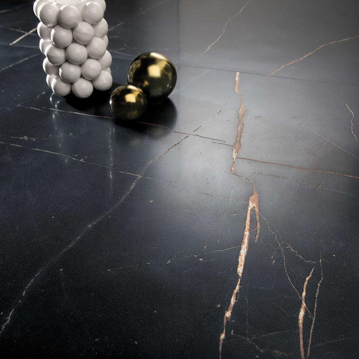 Close-up of Bassano Precious Noir Lux 3D 60 × 120cm marble-effect wall and floor tiles, showcasing deep black tones with striking gold veining and a luxurious polished contemporary finish.