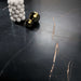 Close-up of Bassano Precious Noir Lux 3D 60 × 120cm marble-effect wall and floor tiles, showcasing deep black tones with striking gold veining and a luxurious polished contemporary finish.