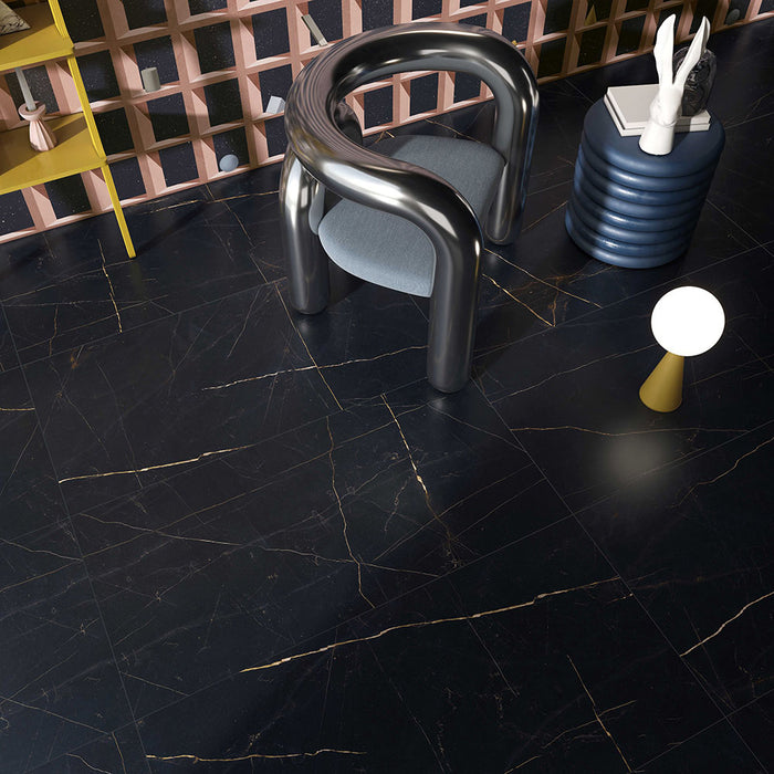 Interior featuring Bassano Precious Noir Lux 3D 60 × 120cm marble-effect wall and floor tiles, styled with sculptural furniture, deep black tones, and striking gold veining for a bold contemporary luxury setting.