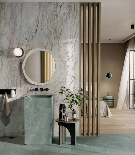 Bathroom interior featuring Bassano Quartz Lux 3D 60 × 120cm marble-effect wall and floor tiles, paired with soft green tones, warm wood accents, and contemporary black fittings for a luxurious modern setting.