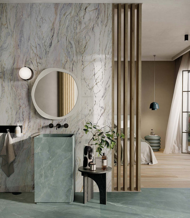 Bathroom interior featuring Bassano Quartz Lux 3D 60 × 120cm marble-effect wall and floor tiles, paired with soft green tones, warm wood accents, and contemporary black fittings for a luxurious modern setting.