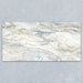 Bassano Quartz Lux 3D 60 × 120cm marble-effect wall and floor tile featuring flowing white, grey, and subtle gold veining with a luxurious contemporary polished finish.