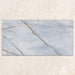 Single tile display of Bassano River Blue Lux 3D 60 × 120cm marble-effect wall and floor tiles, featuring soft blue tones, flowing gold and beige veining, and a polished finish inspired by luxurious natural stone.