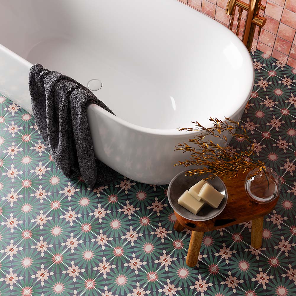 Bathroom featuring Fizaan Festive Blue 20x20cm Moroccan-style porcelain floor tiles, styled with a freestanding white bath, brass fittings and decorative geometric patterns for a bold, characterful look.