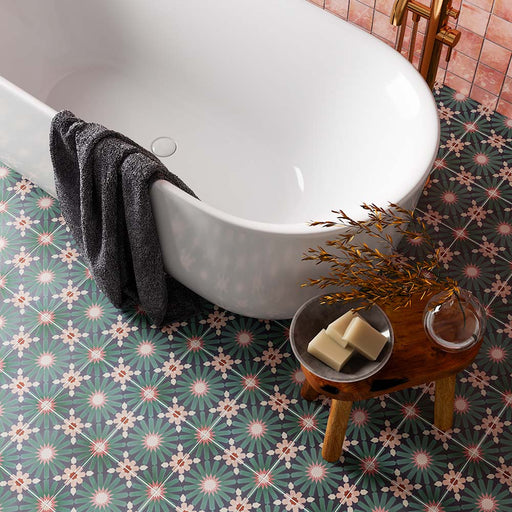 Bathroom featuring Fizaan Festive Blue 20x20cm Moroccan-style porcelain floor tiles, styled with a freestanding white bath, brass fittings and decorative geometric patterns for a bold, characterful look.