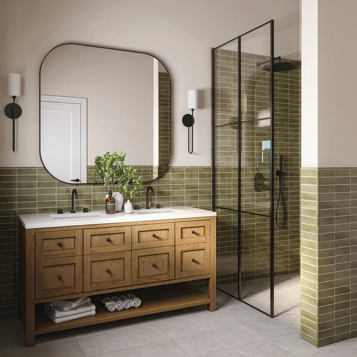 Bathroom setting featuring Atlas Verde Mini Brick 5x15cm gloss wall tiles, laid in a horizontal brick format to introduce depth and rhythm across the space. The rich green tone and reflective gloss finish enhance light and movement, creating a confident yet calming backdrop.