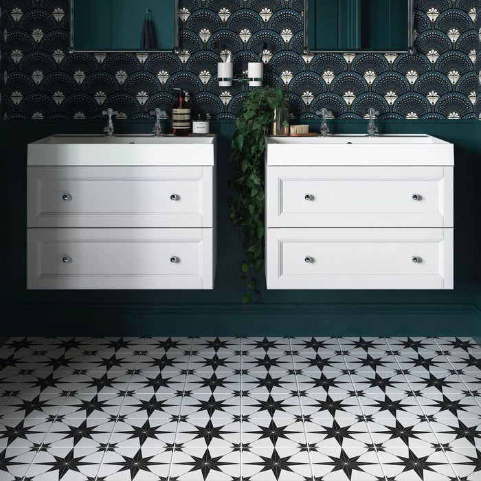 Bathroom setting featuring Pole Star Black Moroccan-style 25x25cm patterned porcelain floor tiles, creating a bold geometric look beneath twin white vanity units and dark cabinetry.