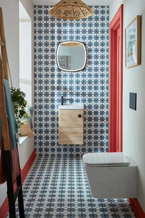 Bathroom interior featuring Mamounia River 20 x 20cm Moroccan style wall and floor tiles in blue and white tones, creating a cohesive patterned scheme, styled with a floating wood vanity, matte black brassware, and warm natural textures for a balanced, characterful space.