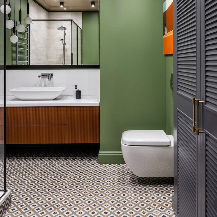 Bathroom featuring Carnaby Park Road 20x20cm Victorian style wall and floor tiles, showcasing a geometric patterned floor in neutral tones, paired with green walls, a wood vanity unit, and modern black-framed shower enclosure.