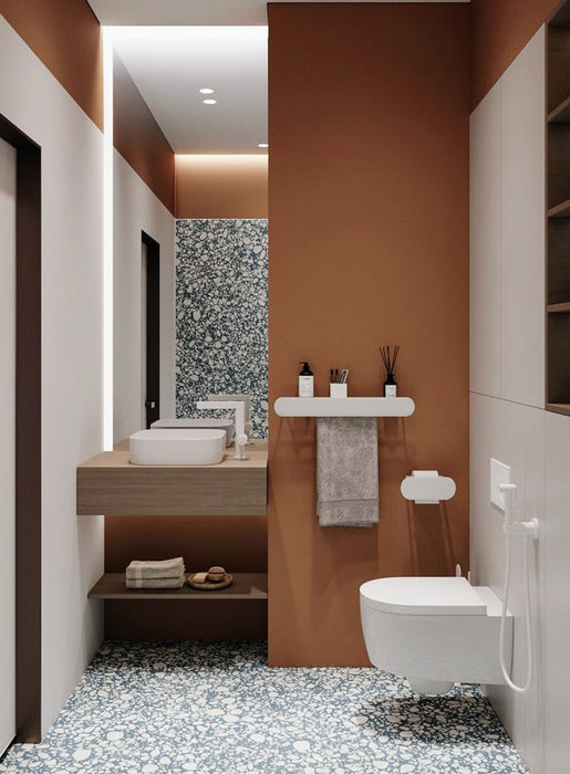 Bathroom setting featuring Chunks POP Terrazzo Blue 60x60cm porcelain tiles, showcasing a bold terrazzo effect with varied aggregate detail, paired with warm terracotta tones, wood finishes and minimalist fittings for a contemporary, design-led look.