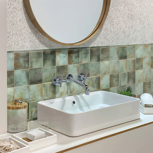 Bathroom featuring Beijing Celadon Green Square 10x10cm Moroccan-style ceramic wall tiles, styled with a white countertop basin, chrome fittings and gold accent details.