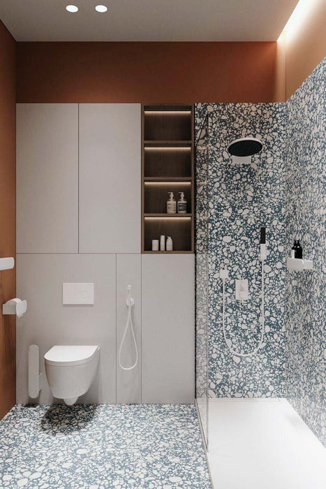 Bathroom setting featuring Chunks POP Terrazzo Blue 60x60cm porcelain tiles, showcasing a bold terrazzo effect with varied aggregate detail, paired with warm terracotta tones, soft grey cabinetry and clean, minimalist fittings for a contemporary finish.