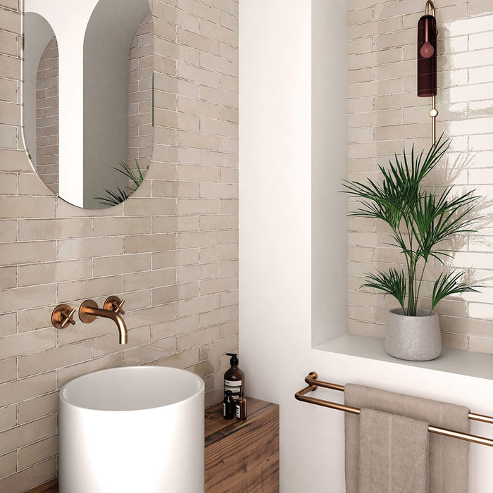 Madison Oatmeal Brick Wall Tiles 6x24.6cm — showcased in a calm, modern bathroom setting. The soft oatmeal tones and handcrafted finish create a warm, organic feel, pairing perfectly with brass fixtures and natural wood for a timeless, spa-inspired design.