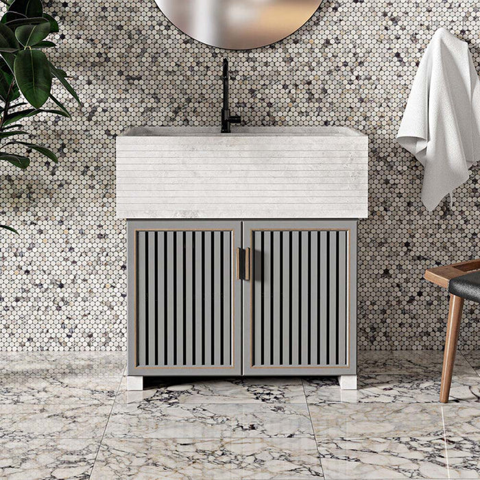 Bathroom interior featuring Fitzrovia Picasso 30.5 x 61cm honed natural marble floor tiles, showcasing a light base with bold, multi-tonal veining, paired with a small-format mosaic feature wall, a fluted vanity unit, and soft neutral tones for a layered, design-led finish.