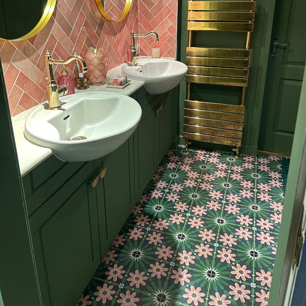 Bathroom featuring Fizaan Autumn Moroccan-style 20×20cm porcelain floor tiles, showcasing a green and pink geometric floral pattern paired with dark green cabinetry and brass fittings.