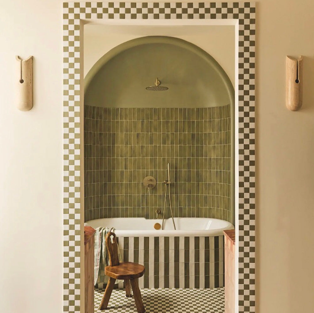 Atlas Verde Mini Brick Gloss Tile 5x15cm used in a curved shower alcove, featuring rich green gloss tiles laid in a vertical stacked layout with matching green chequerboard floor for a bold, contemporary bathroom design.