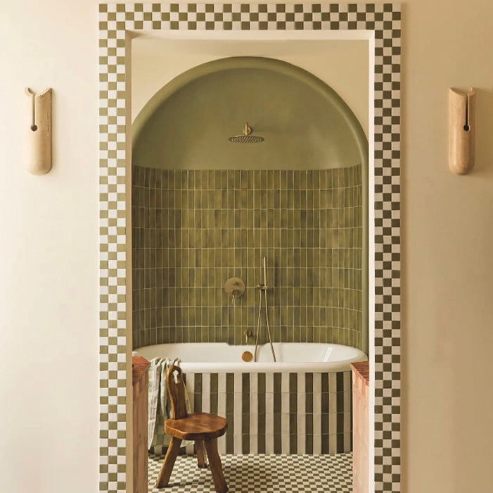 Atlas Verde Mini Brick Gloss Tile 5x15cm used in a curved shower alcove, featuring rich green gloss tiles laid in a vertical stacked layout with matching green chequerboard floor for a bold, contemporary bathroom design.