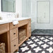 Alhambra Cathedral 20x20cm Moroccan tiles in a modern bathroom with light wood cabinetry, white subway walls, and a walk-in shower — featuring a striking black and white geometric pattern that adds bold character to the space.