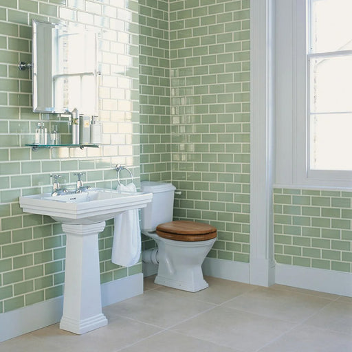 Bathroom featuring Finchley Lime Green 7.5 × 15cm ceramic wall tiles with a crackle glaze finish, laid in a classic brick pattern to create a fresh, light and timeless bathroom design.
