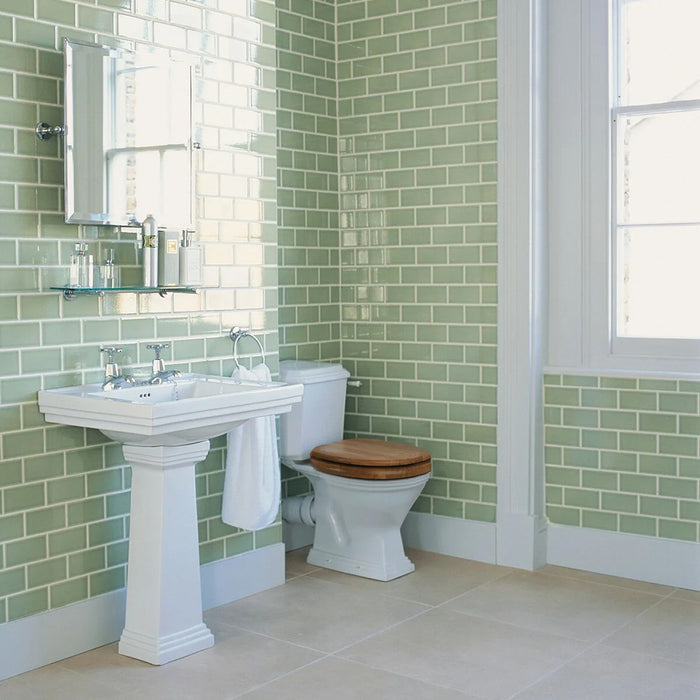 Bathroom featuring Finchley Lime Green 7.5 × 15cm ceramic wall tiles with a crackle glaze finish, laid in a classic brick pattern to create a fresh, light and timeless bathroom design.