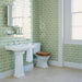 Bathroom featuring Finchley Lime Green 7.5 × 15cm ceramic wall tiles with a crackle glaze finish, laid in a classic brick pattern to create a fresh, light and timeless bathroom design.