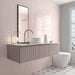 Zellij Pink Mist brick tile in a 6.5cm x 20cm format, Moroccan style, soft blush pink tones with subtle tonal variation, glossy glazed finish, shown in a contemporary bathroom wall setting with a floating vanity and modern fittings.