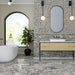 Bathroom interior featuring Fitzrovia Picasso 5 x 20cm honed natural marble tiles, installed across the wall in a linear layout, showcasing intricate multi-tonal veining, paired with matching large-format marble floor tiles, a wood vanity unit, and soft architectural details for a refined, design-led space.
