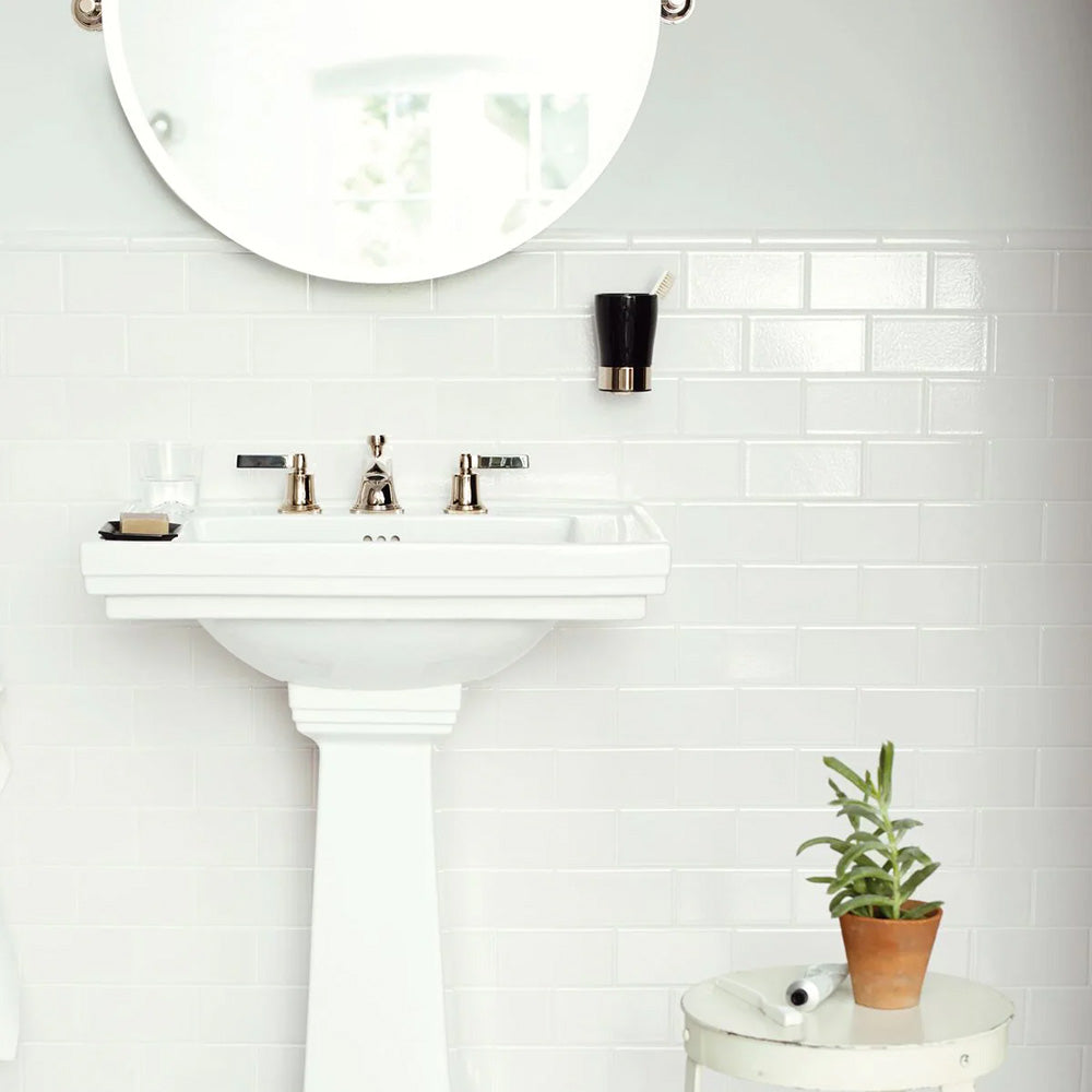 Bathroom wall featuring Finchley White 7.5 × 15cm ceramic wall tiles with a crackle glaze finish, laid in a classic brick pattern to create a bright, timeless and elegant washroom setting.