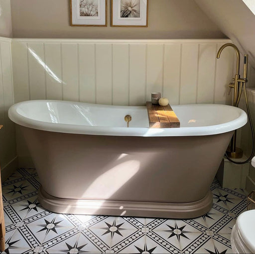 Galata White Moroccan Style 20x20cm tiles in a bathroom setting featuring a freestanding beige bathtub with brass fixtures, white wall panelling, and patterned floor tiles with black star motifs and geometric borders.