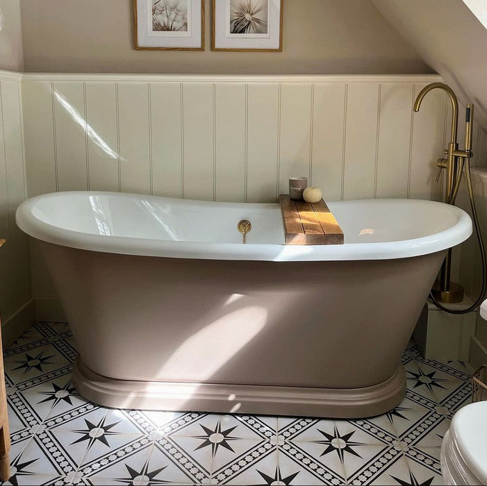 Galata White Moroccan Style 20x20cm tiles in a bathroom setting featuring a freestanding beige bathtub with brass fixtures, white wall panelling, and patterned floor tiles with black star motifs and geometric borders.