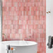 Zellij Rose Pink Brick Moroccan style tiles, 6.5cm x 20cm, brick layout with soft rose pink and blush tones, subtle tonal variation, glossy glazed finish, Moroccan-inspired design, bathroom bath setting.