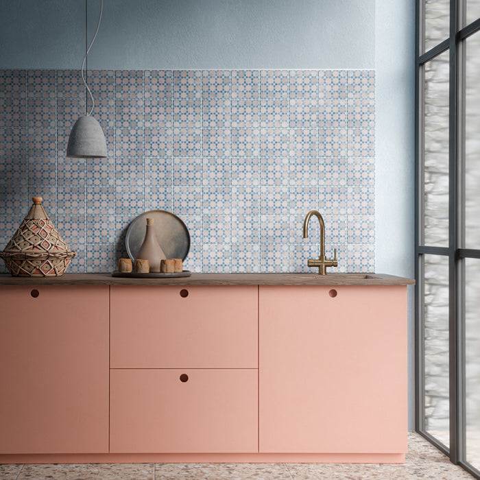 Kitchen featuring Bedouin Mequinez Blue 15cm x 15cm Moroccan style patterned wall tiles, showcasing a delicate blue geometric design, paired with soft pink cabinetry, warm wood details and brass fixtures.