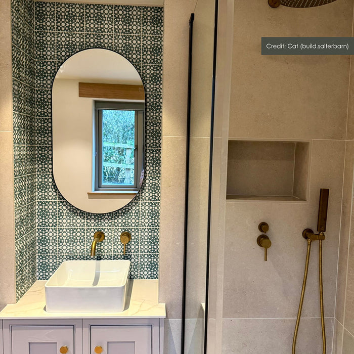 Bathroom featuring Bedouin Tetuan Green 15x15cm Moroccan-style patterned wall tiles, styled as a vanity feature wall with a contemporary basin, brushed brass fixtures, neutral stone-effect tiles and a walk-in shower.