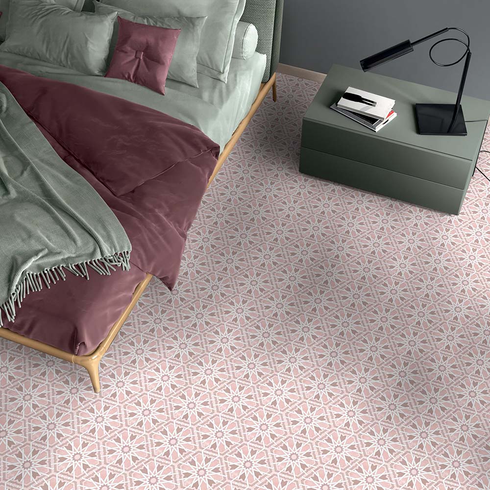 Maroush Mareshan Rose 18.7x21.6cm Moroccan hexagonal tiles with a pink and white geometric floral pattern, styled in a modern bedroom with soft sage and mauve bedding for a warm, elegant finish.