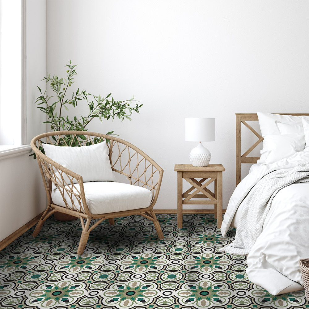 Bedroom interior featuring Europa Budapest 20x20cm Victorian Moroccan style floor tiles in green and cream tones, styled with rattan chair, bed, white bedding and plant in bright natural bedroom setting.