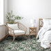 Bedroom interior featuring Europa Budapest 20x20cm Victorian Moroccan style floor tiles in green and cream tones, styled with rattan chair, bed, white bedding and plant in bright natural bedroom setting.